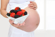 canvas print picture Pregnant Woman Holding Fruit