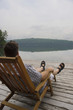 Photo: Man relaxing by a lake Man relaxing by a lake
