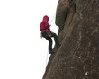 Climber on steep cliff.