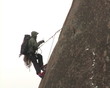 Tether climber mounted on top of cliff.