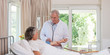 Foto: Senior doctor taking the blood pressure of his patient Senior doctor taking the blood pressure of his patient