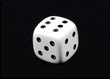 Photo: White dice cube toy on black background White dice cube toy on black background