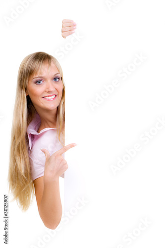 Photo: blonde frau zeigt mit finger auf werbetafel blonde frau zeigt mit finger auf werbetafel