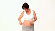 Pregnant woman using a measuring tape