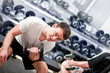 Young man lifting bumbbell in sport club Young man lifting bumbbell in sport club