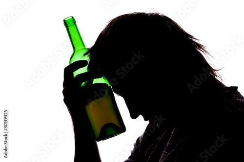 Photo: Silhouette of sad man drinking alcohol Silhouette of sad man drinking alcohol