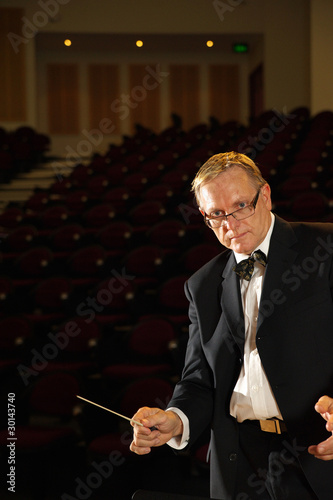 Photo: Male symphony conductor in action Male symphony conductor in action