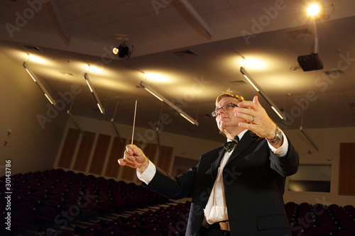 Photo: Male symphony conductor in action Male symphony conductor in action