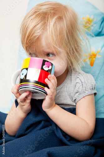 Photo: a sick girl is drinking a medcine a sick girl is drinking a medcine