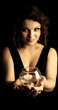 Woman holding a glass with a candle inside Woman holding a glass with a candle inside