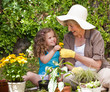Foto: Happy Grandmother with her granddaughter working in the garden Happy Grandmother with her granddaughter working in the garden