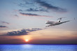 Private jet cruising at sunset