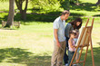 Family painting together in the park