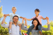 Parents giving  children a piggyback