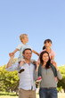 Parents giving  children a piggyback