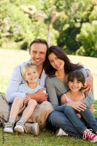 Photo: Family sitting in the park Family sitting in the park