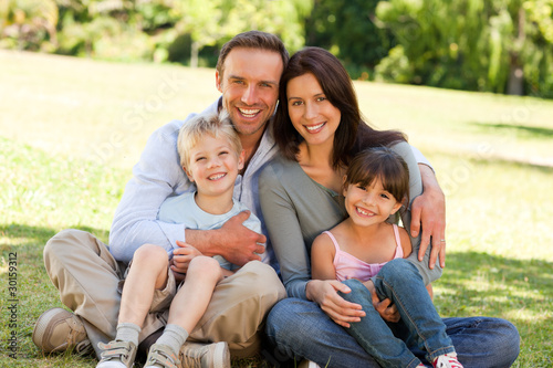 Photo: Family sitting in the park Family sitting in the park