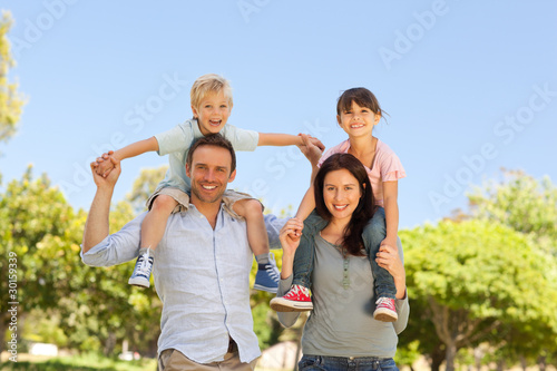 Photo: Parents giving children a piggyback Parents giving children a piggyback