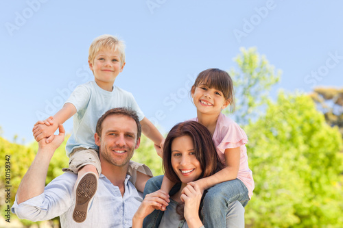 Photo: Parents giving children a piggyback Parents giving children a piggyback