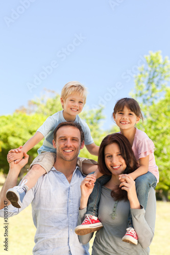 Photo: Parents giving children a piggyback Parents giving children a piggyback