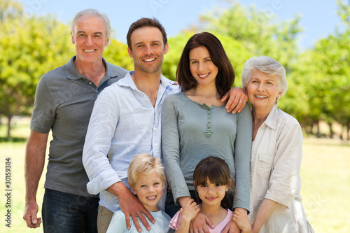 Photo: Family standing in the park Family standing in the park