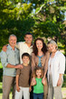 Foto: Family looking at the camera in the park Family looking at the camera in the park