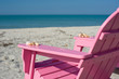 pink adirondack chair on beach
