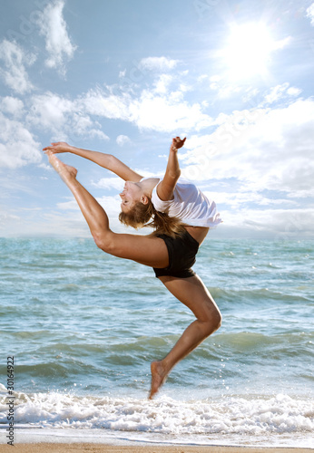 Photo: Beautiful young woman doing fitness exercise Beautiful young woman doing fitness exercise