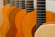 Row of classical acoustic guitars in musical store. Close-up vie Row of classical acoustic guitars in musical store. Close-up vie