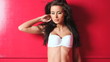 Adorable female in white lingerie is moving on red background