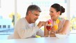 Middle aged couple drinking cocktails
