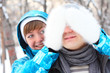 Photo: Young playful couple has a fun. Winter Young playful couple has a fun. Winter