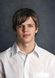 portrait of a cute young man on a dark background. portrait of a cute young man on a dark background.