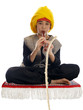 boy playing the flute charming a rope