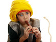 boy playing the flute charming a rope