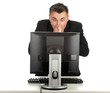 frightened young businessman working on computer