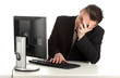 tired young businessman in black suit with computer