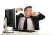 tired yawning businessman in black suit with computer