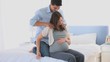 Man giving a massage to his pregnant wife