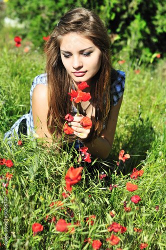 Photo: girl on meadow with poppy girl on meadow with poppy