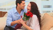 Man bringing a bunch of flowers to his wife