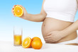 Healthy pregnancy. Pregnant Woman make orange juice. Healthy pregnancy. Pregnant Woman make orange juice.