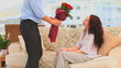Man bringing a bunch of flowers to his wife