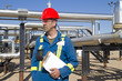 Male gas field operator inspects compressor site Male gas field operator inspects compressor site