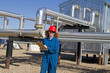 female gas field operator inspects compressor site female gas field operator inspects compressor site