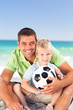 Happy father playing football with his son