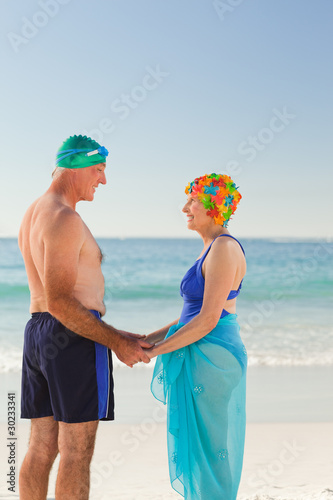 Photo: Enamored elderly couple at the beach Enamored elderly couple at the beach