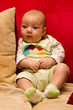 Cute baby sitting on sofa