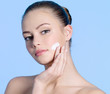 Teen girl applying cream on cheek