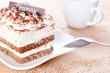 Portion of tiramisu dessert and a cup of coffee